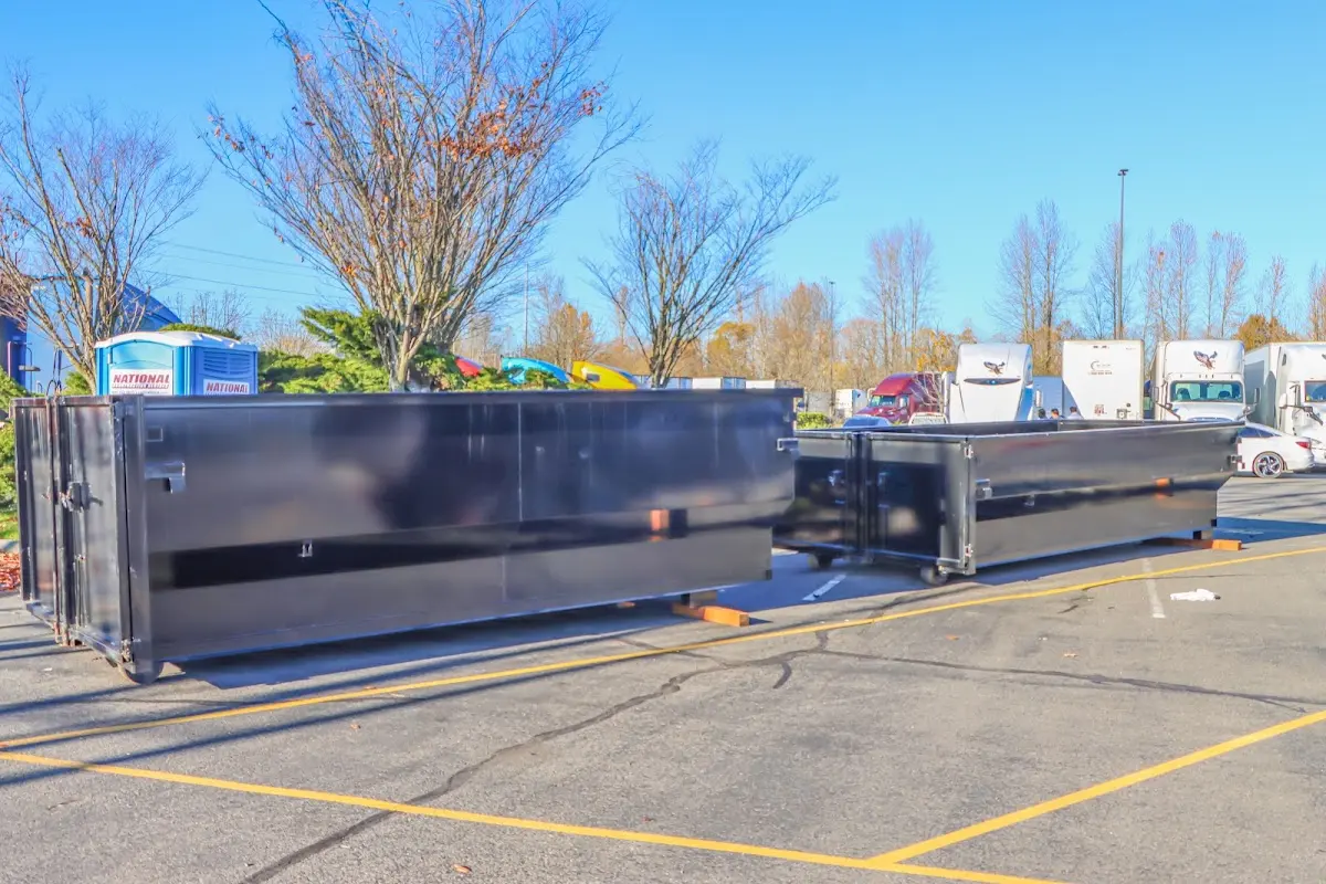 Professional dumpster rental service with roll-off container on residential driveway in Elkridge